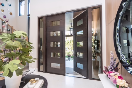 Custom impact-rated wood door with architectural detail on Florida home