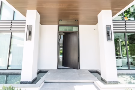 Pivot entrance door with hidden rotating system on Florida home
