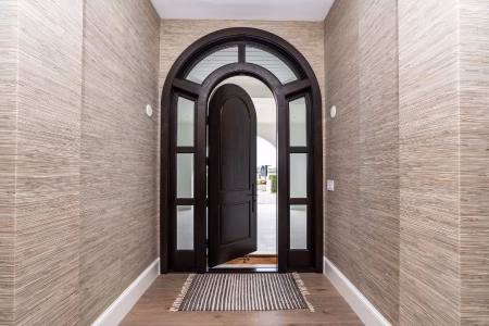 Arch-top exterior wood door with curved silhouette for a traditional entrance